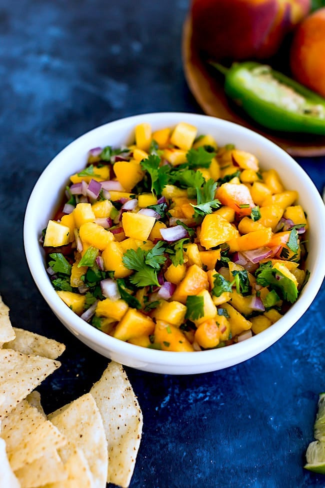 Peach Salsa Is An Easy Summer Snack That Can Be Made In Minutes. Serve The Salsa With Chips Or Use The Salsa As A Topping For Tacos, Grilled Chicken, Fish, Or Pork. This Salsa Recipe Is A Summer Favorite! #peach #salsa #easyrecipe #glutenfree #vegan #vegetarian #summer Fresh Peach Salsa Recipe in a bowl