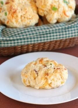 Cheddar biscuits with bacon and onion on plate and in basket