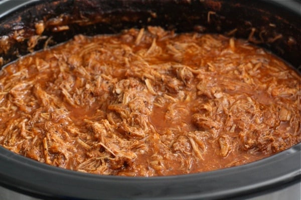 slow-cooker-pulled-pork slow cooker pulled pork in crock pot ready to serve