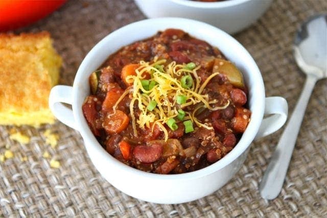 quinoa-chili2 bowl of vegan chili garnished with cheese and scallions