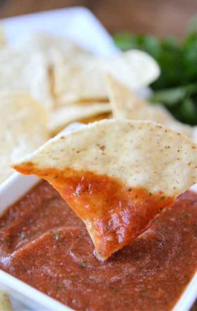 Restaurant Style Salsa Recipe on twopeasandtheirpod.com LOVE this easy blender salsa! Chip dipped in Restaurant Style Salsa