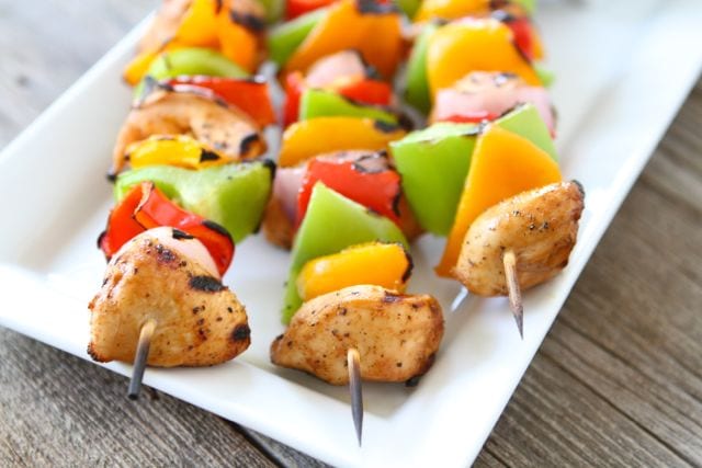 Grilled Chicken Fajita Kabobs from Two Peas and Their Pod Three chicken kabobs with peppers served on platter