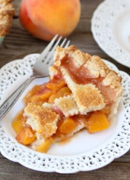 Peach pie slice on white plate