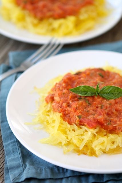 Baked Spaghetti Squash with Creamy Roasted Red Pepper Sauce | Two Peas and Their Pod #recipe #glutenfree #vegetarian spaghetti squash with red pepper sauce on plates