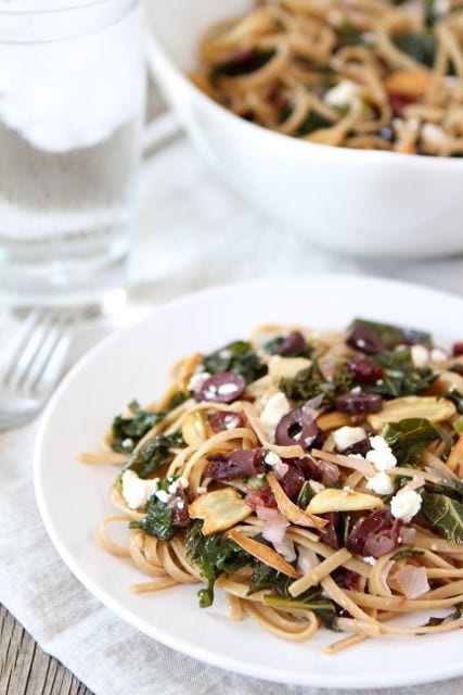 Pasta with Kale, Kalamata Olives, Dried Cranberries, Toasted Garlic, & Feta (www.twopeasandtheirpod.com) #recipe #vegetarian
