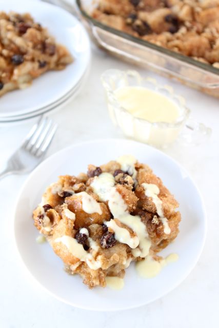 Bread Pudding with Vanilla Custard Sauce | Two Peas and Their Pod | www.twopeasandtheirpod.com bread pudding slices plated and drizzled with bread pudding sauce