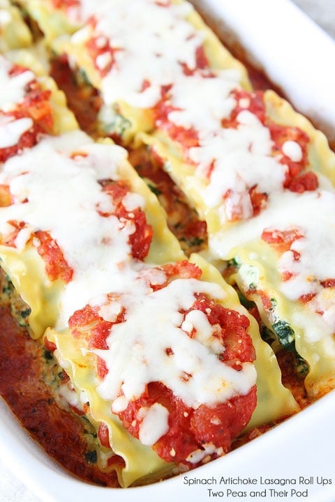 Spinach Artichoke Lasagna Roll Ups on twopeasandtheirpod.com The BEST lasagna roll ups recipe! Spinach Artichoke Lasagna Roll Ups Recipe with sauce