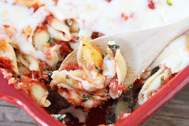 Baked Pasta with Spinach and Ricotta Recipe on www.twopeasandtheirpod.com An easy weeknight meal! ricotta spinach pasta shells smothered in marinara sauce