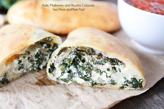 Kale, Mushroom, and Ricotta Calzones on twopeasandtheirpod.com An easy and tasty meatless meal! Homemade Calzones ready to serve