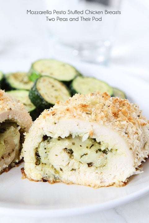 Mozzarella Pesto Stuffed Chicken Breasts Recipe on twopeasandtheirpod.com Baked chicken with a cheesy pesto filling and a panko parmesan crust! Easy to make too! Mozzarella Pesto Stuffed Chicken Breast Recipe