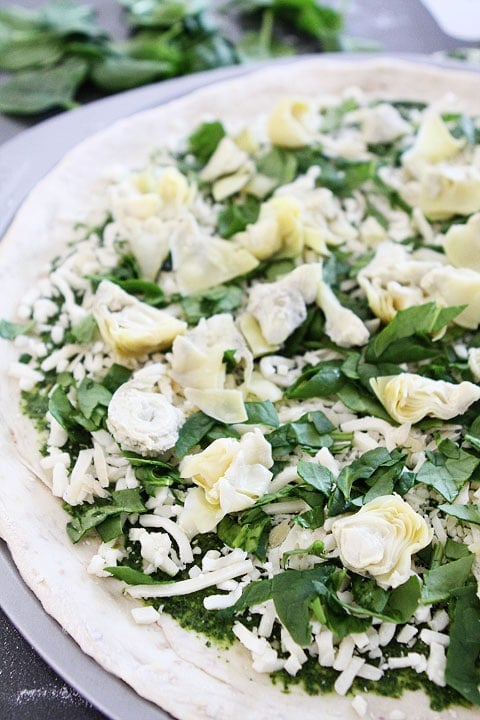 Spinach Artichoke Pesto Pizza on twopeasandtheirpod.com Spinach Artichoke Pesto Pizza Recipe on twopeasandtheirpod.com