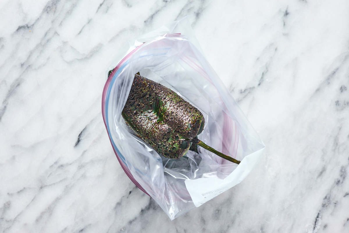 charred poblano pepper steaming in bag.