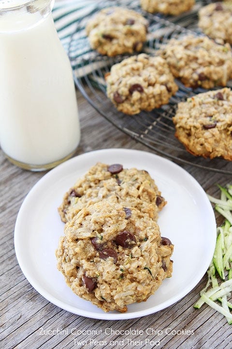 Zucchini Coconut Chocolate Chip Cookie Recipe are the perfect cookies for using up garden zucchini. You will LOVE these healthy cookies! #zucchini #zucchinicookies #cookies #recipe #dessert #vegetarian #baking #chocolatechip Zucchini cookies on plate with glass of milk