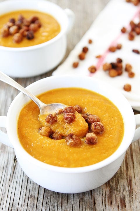 Slow Cooker Butternut Squash with Maple Roasted Chickpeas on twopeasandtheirpod.com The perfect soup recipe for fall! slow cooker butternut squash soup in bowl with chickpeas and spoon.