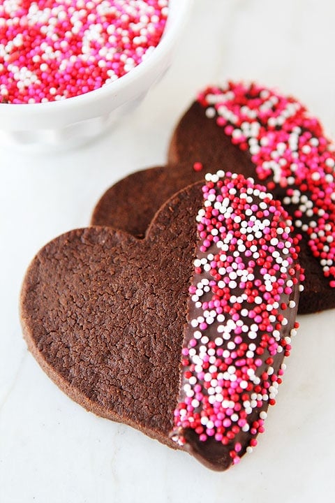 Chocolate Shortbread Dipped in Chocolate Chocolate Shortbread Heart Cookies on twopeasandtheirpod.com Fun and festive cookies!