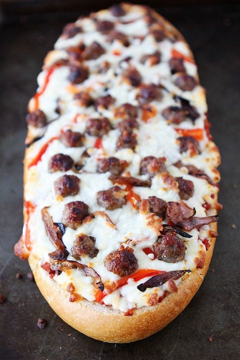 French Bread Pizza Recipe | Two Peas and Their Pod French Bread Pizza with Sausage, Caramelized Onions, and Roasted Red Peppers