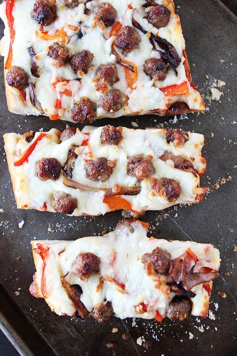 Easy French Bread Pizza Recipe | Two Peas and Their Pod Hot French Bread Pizza Slices on Baking Sheet