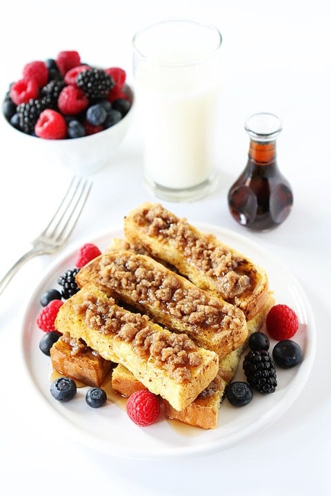 Cinnamon Streusel Baked French Toast Sticks Recipe on twopeasandtheirpod.com So easy to make and SO good! French Toast Sticks topped with Cinnamon Streusel and berries