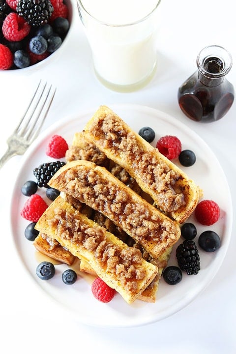 Cinnamon Streusel Baked French Toast Sticks Recipe on twopeasandtheirpod.com WOW! These are so good! Homemade French Toast Sticks served with berries and maple syrup