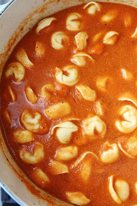 Creamy Tomato Tortellini Soup Recipe on twopeasandtheirpod.com tomato tortellini soup in large soup pot