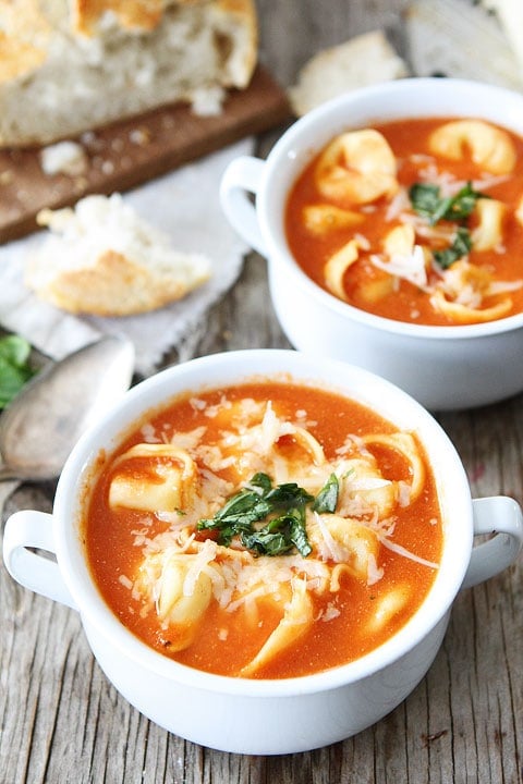 Creamy Tomato Tortellini Soup Recipe on twopeasandtheirpod.com This easy soup is a family favorite! Serve for lunch or dinner! Tortellini Soup in small soup bowls ready for serving