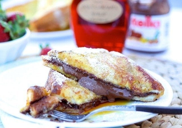 Nutella Stuffed French Toast Recipe Nutella Stuffed French Toast Recipe on twopeasandtheirpod.com. This decadent French toast recipe is a real treat!
