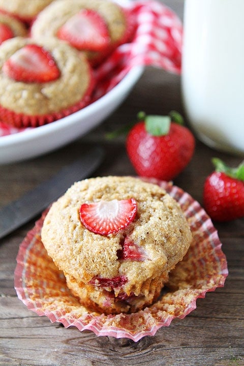 Whole Wheat Strawberry Banana Muffins Recipe on twopeasandtheirpod.com. Love these quick and easy muffins! They are great for breakfast or snack time! Strawberry Banana Muffins served with glass of milk