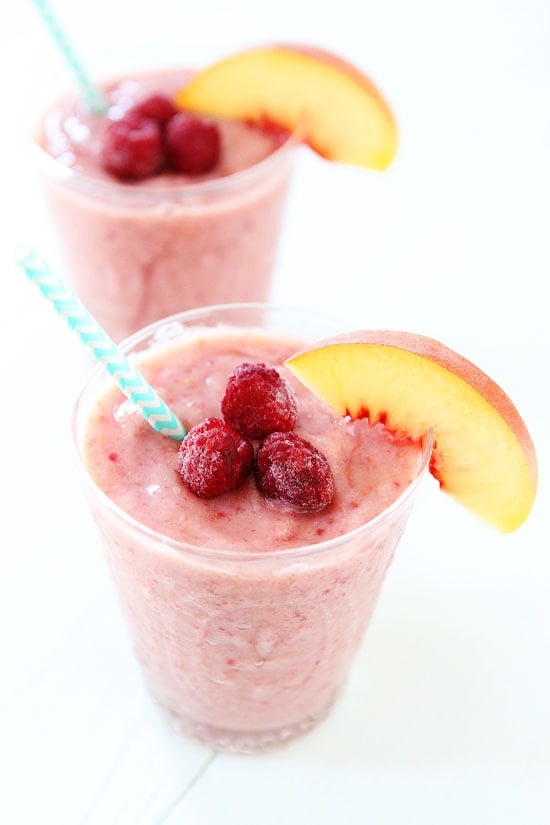 Peach Raspberry Smoothie Recipe on twopeasandtheirpod.com Love this healthy smoothie! Perfect for breakfast, snack time, or dessert! #vegan #glutenfree Peach Raspberry Smoothie topped with fresh fruit