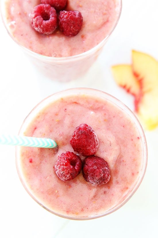 Peach Raspberry Smoothie Recipe on twopeasandtheirpod.com Love this easy smoothie recipe! #smoothie #vegan #glutenfree Raspberry Smoothie with fresh raspberries on top