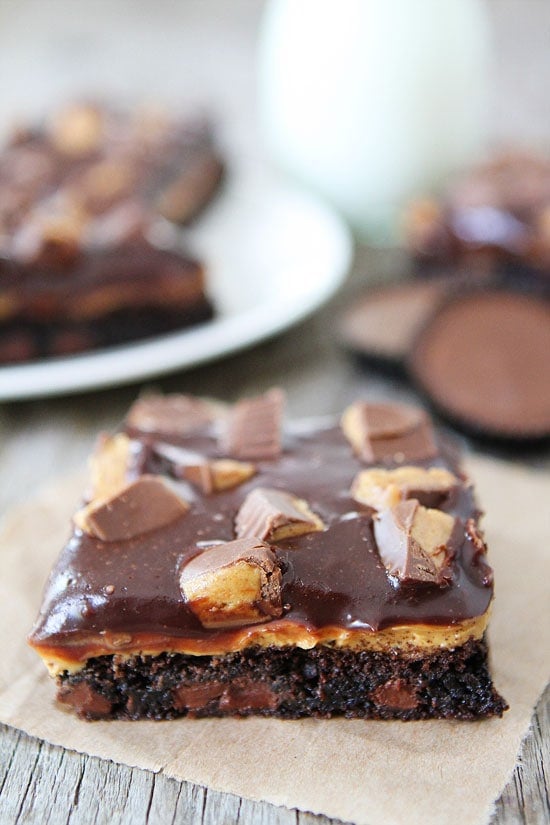 Chocolate Peanut Butter Brownie Recipe on twopeasandtheirpod.com Fudgy brownies with a peanut butter filling and chocolate ganache topping! The BEST brownies ever! Peanut Butter Brownies layered with chocolate and peanut butter