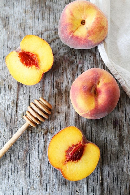 Honey Peach Muffins Honey Peach Muffins with Oat Streusel Topping Recipe on twopeasandtheirpod.com