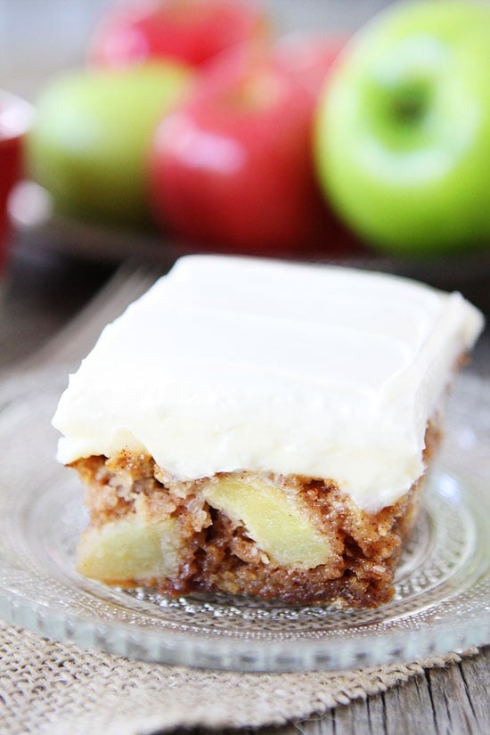 Apple Cake with Cream Cheese Frosting Recipe on twopeasandtheirpod.com Love this easy apple cake! #apple #cake fresh apple cake with frosting on glass serving plate