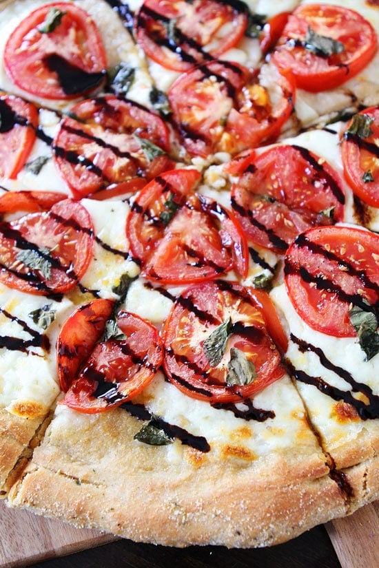 Caprese Pizza Recipe Caprese Pizza Recipe on twopeasandtheirpod.com One of our very favorite pizza recipes! #pizza