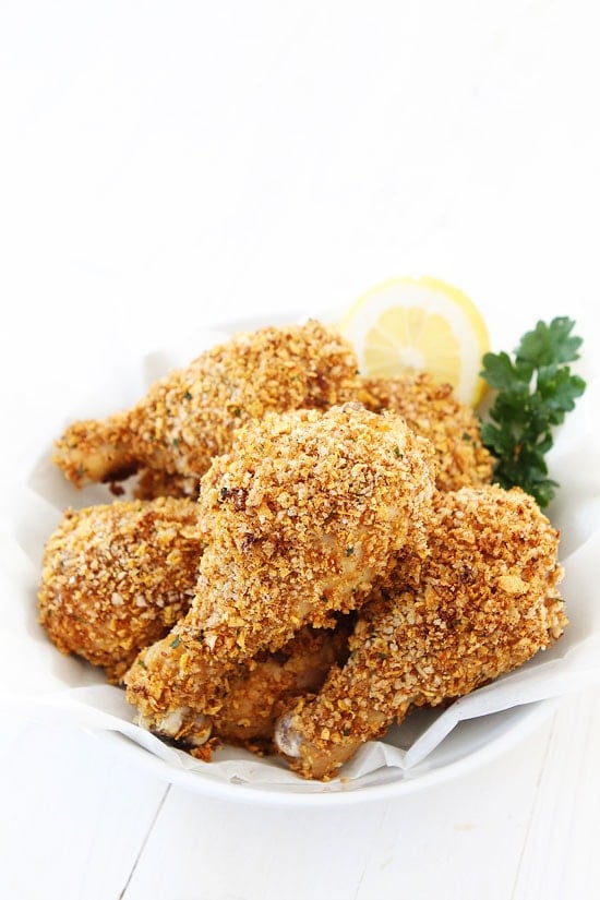 Buttermilk Oven "Fried" Chicken Recipe on twopeasandtheirpod.com This fried chicken is easy to make and easy to clean up! You won't miss the deep fryer, I promise! #chicken buttermilk oven fried chicken drumsticks in serving dish