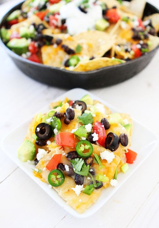 Three Cheese Skillet Nachos Recipe on twopeasandtheirpod.com These nachos are easy to make and loaded with cheese and toppings! #nachos #snack Three Cheese Skillet Nachos Recipe on twopeasandtheirpod.com