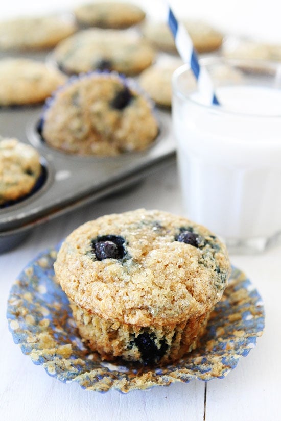 Vegan Banana Blueberry Muffins Recipe on twopeasandtheirpod.com These healthy whole wheat muffins are great for breakfast or snack time! banana blueberry muffins out of the oven ready to eat