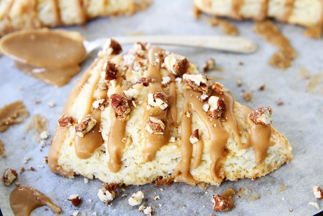 Maple Scones Recipe on twopeasandtheirpod.com Light and fluffy scones drizzled with a sweet maple glaze and candied pecans! LOVE these scones! Maple Scones Recipe with candied pecans