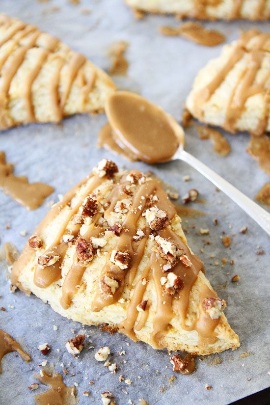 Maple Scones Recipe on twopeasandtheirpod.com Light and fluffy scones drizzled with a sweet maple glaze! A wonderful breakfast treat! Maple Scones with pecans