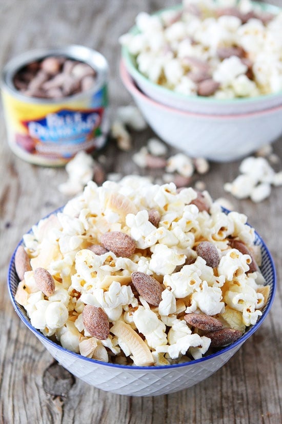 Toasted Coconut Kettle Corn Recipe on twopeasandtheirpod.com This easy kettle corn recipe is made with coconut oil and has toasted coconut chips and toasted coconut almonds! A coconut lover's dream snack! Toasted Coconut Kettle Corn Recipe