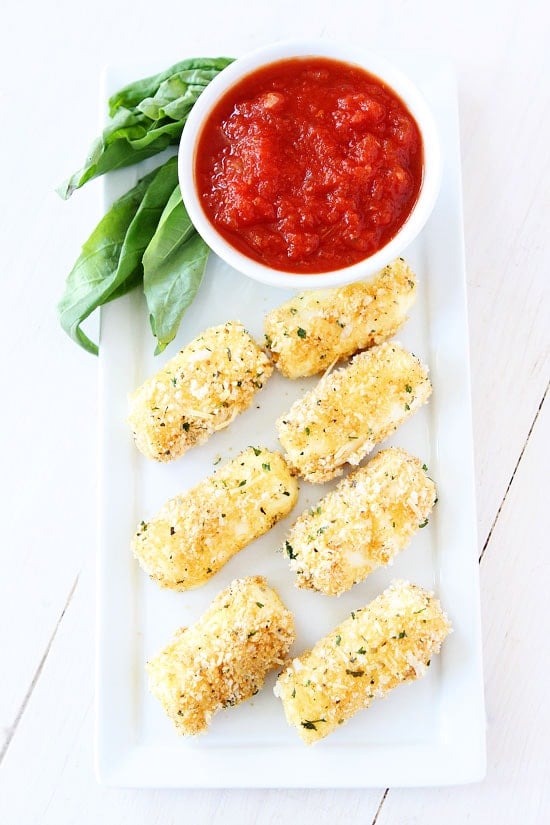 Baked Mozzarella Sticks Recipe on twopeasandtheirpod.com Everyone loves these easy and cheesy baked mozzarella sticks! They are perfect for parties or snack time! Baked Mozzarella Sticks Recipe