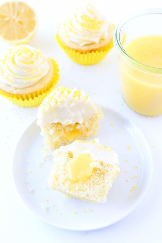Lemon Curd Cupcakes Recipe on twopeasandtheirpod.com Lemon cupcakes filled with lemon curd and topped with buttercream frosting. These are the BEST cupcakes! Lemon Curd Cupcakes Recipe