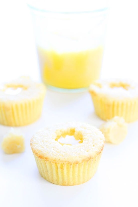 Lemon Curd Cupcakes Recipe on twopeasandtheirpod.com Lemon cupcakes filled with lemon curd and topped with buttercream frosting. These cupcakes are AMAZING! Lemon Curd Cupcakes Recipe
