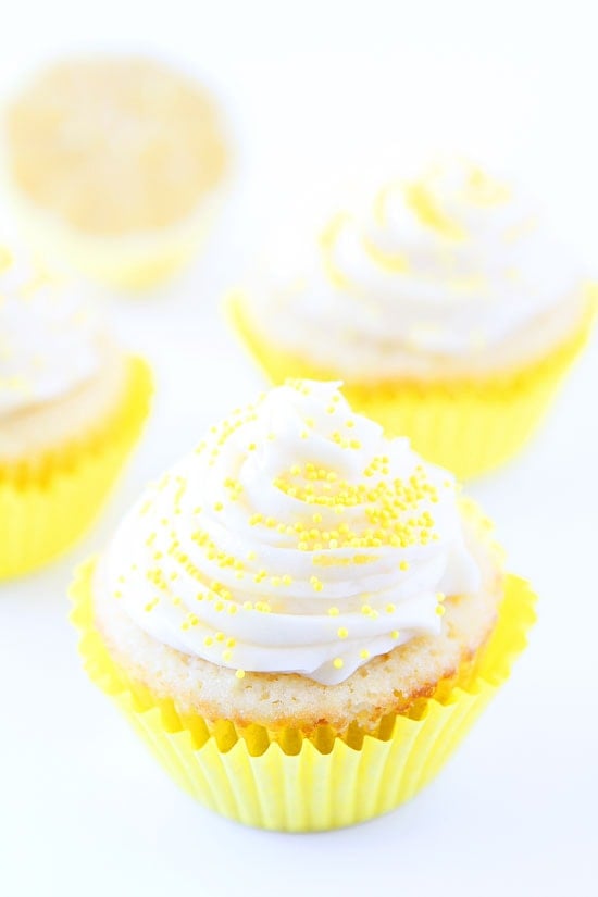 Lemon Curd Cupcakes Recipe on twopeasandtheirpod.com Lemon cupcakes filled with lemon curd and topped with buttercream frosting. SO good! Lemon Curd Cupcakes Recipe