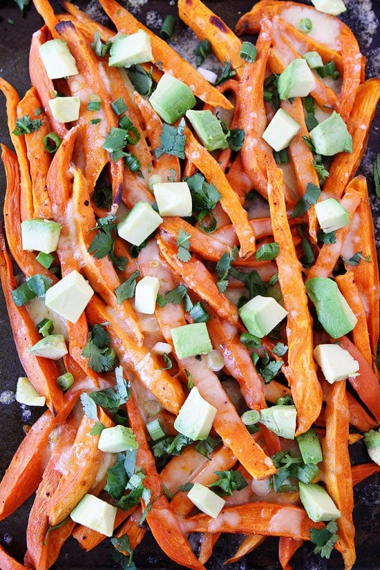 Loaded Cheese Fries Recipe on twopeasandtheirpod.com Baked sweet potato fries topped with all of your favorite toppings! These fries are perfect for game day, parties, or any day! Sweet Potato Cheese Fries
