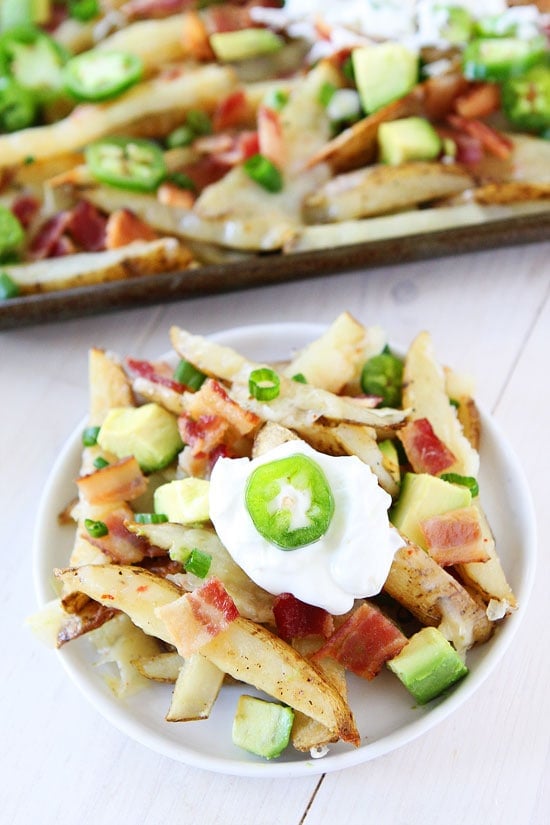 Loaded Cheese Fries Recipe on twopeasandtheirpod.com Baked fries that are loaded with lots of tasty toppings! These fries are a great game day snack! How to Make Cheese Fries