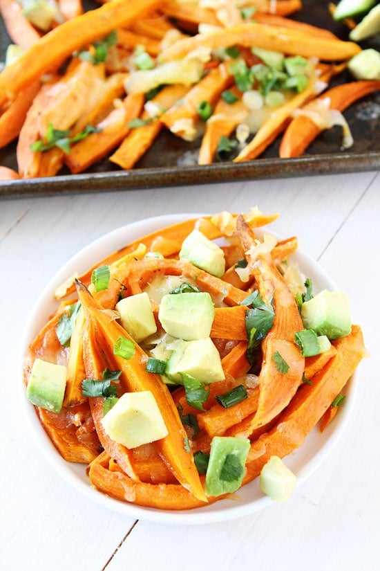 Loaded Cheese Fries Recipe on twopeasandtheirpod.com Baked sweet potato fries with lots of tasty toppings! A great game day snack! How to make cheese fries with sweet potatoes