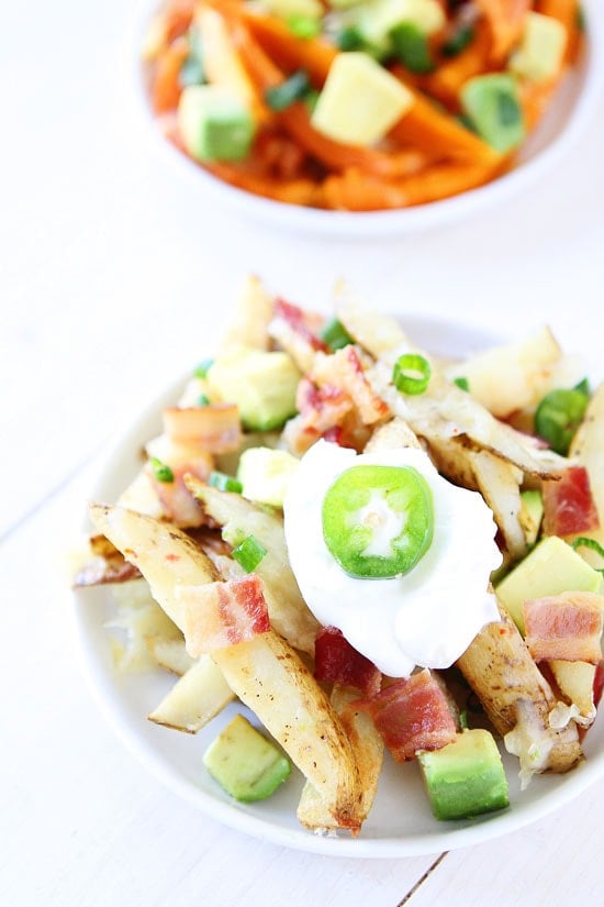Loaded Cheese Fries Recipe on twopeasandtheirpod.com Loaded Cheese Fries with bacon, sour cream and jalepenos