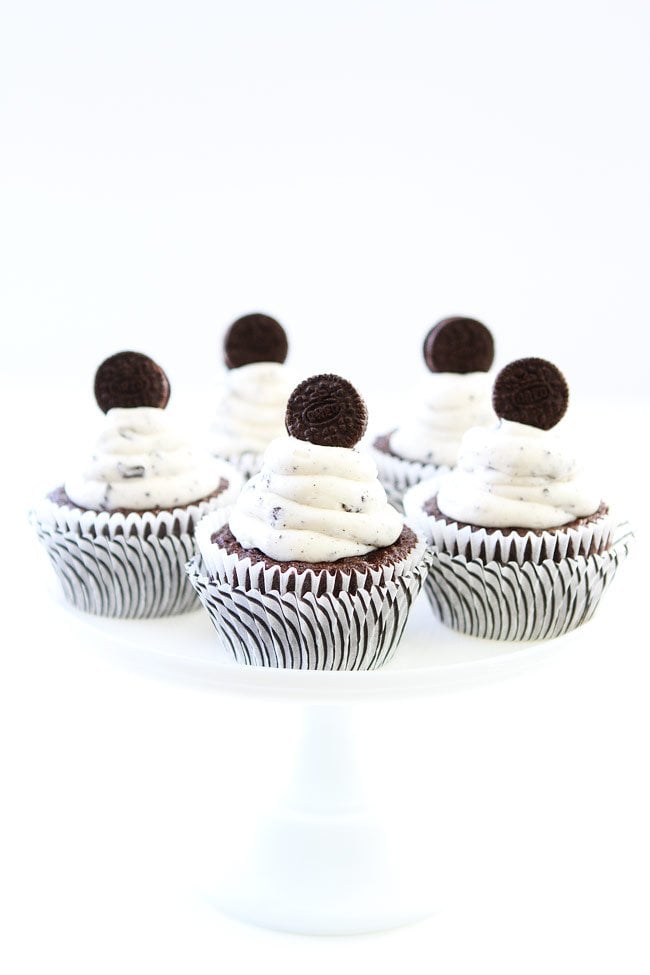 Cookies and Cream Cupcakes Recipe on twopeasandtheirpod.com Chocolate cupcakes with cookies and cream frosting and an Oreo surprise inside! They are perfect for any celebration! Cookies and Cream Cupcakes Recipe