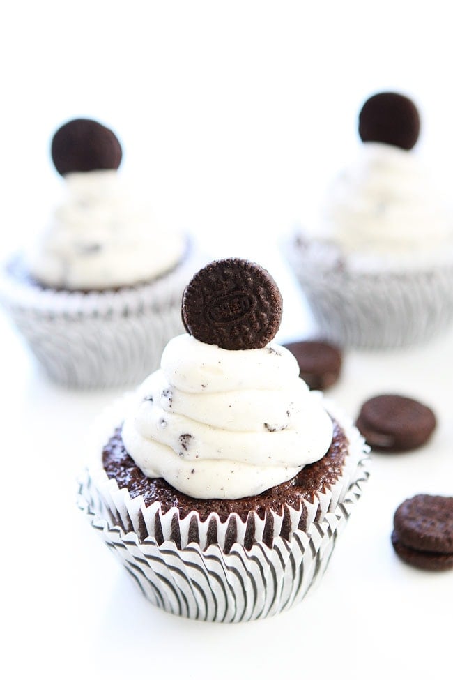 Cookies and Cream Cupcakes Recipe on twopeasandtheirpod.com Chocolate cupcakes with cookies and cream frosting and an Oreo surprise inside! They are the BEST cupcakes! Cookies and Cream Cupcakes Recipe