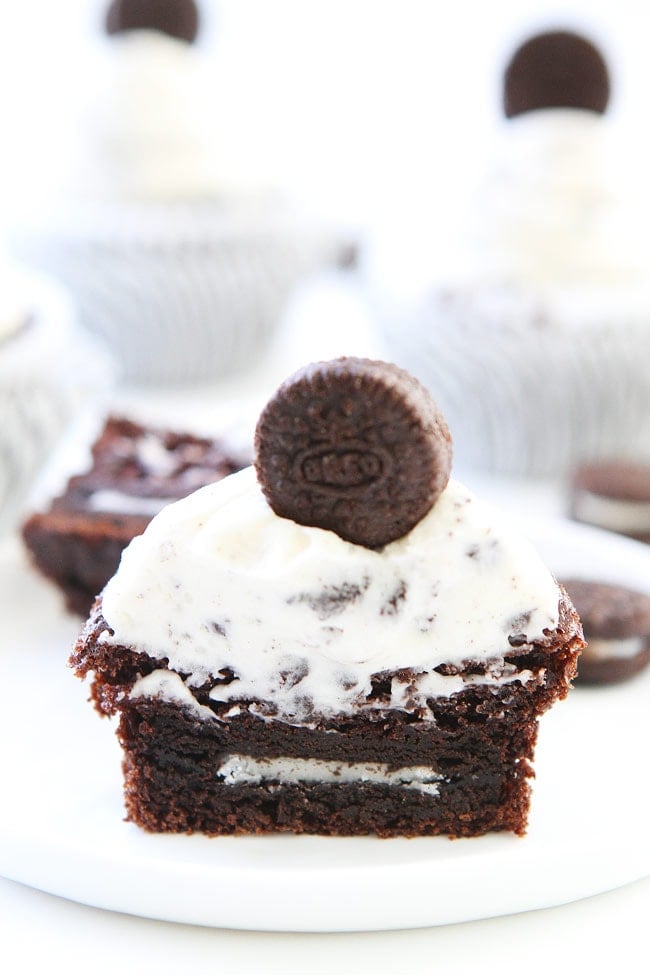 Cookies and Cream Cupcakes Recipe on twopeasandtheirpod.com Chocolate cupcakes with cookies and cream frosting and an Oreo surprise inside! They are perfect for birthdays or any celebration! Cookies and Cream Cupcakes Recipe